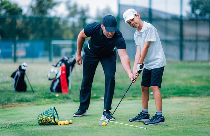 junior golfer taking lessons