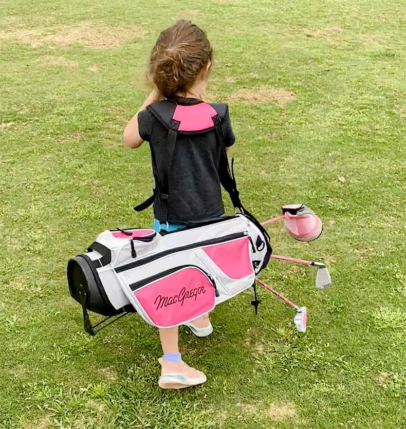 young girl learning to play golf