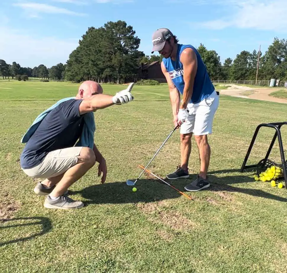 beginner golfer taking first golf lesson